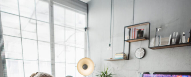 A diverse group of men watching a soccer game at home and cheering on their favorite team.