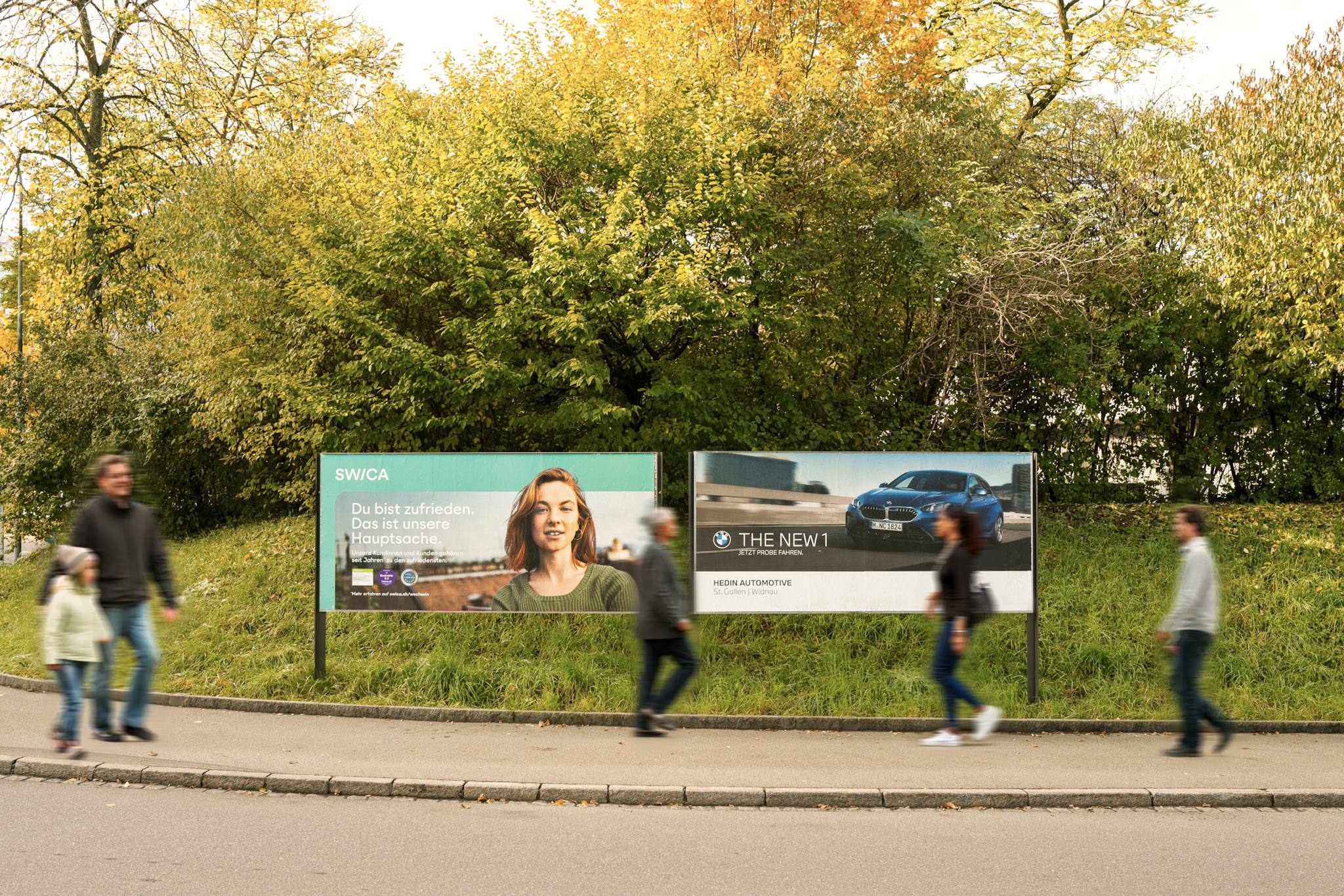 Two advertising spaces are in the image along with 5 people walking by
