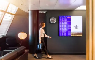 Advertising space visible and woman walking in the Swiss Lounge