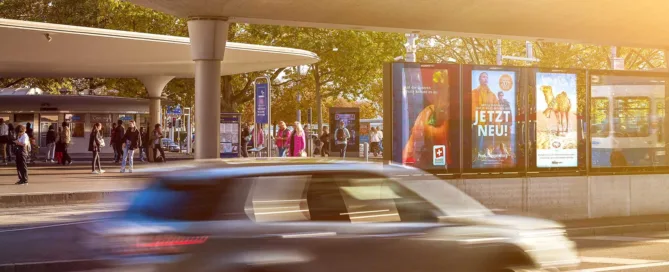 Auto fährt beim Bellevue an DOOH-Screens vorbei