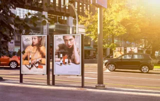Two posters by the roadside in Geneva and two cars on the road