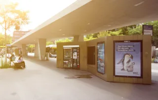 The image shows illuminated posters at Oerlikon station