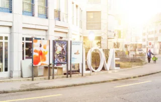 Poster locations in Winterthur with a woman on a bicycle passing by.