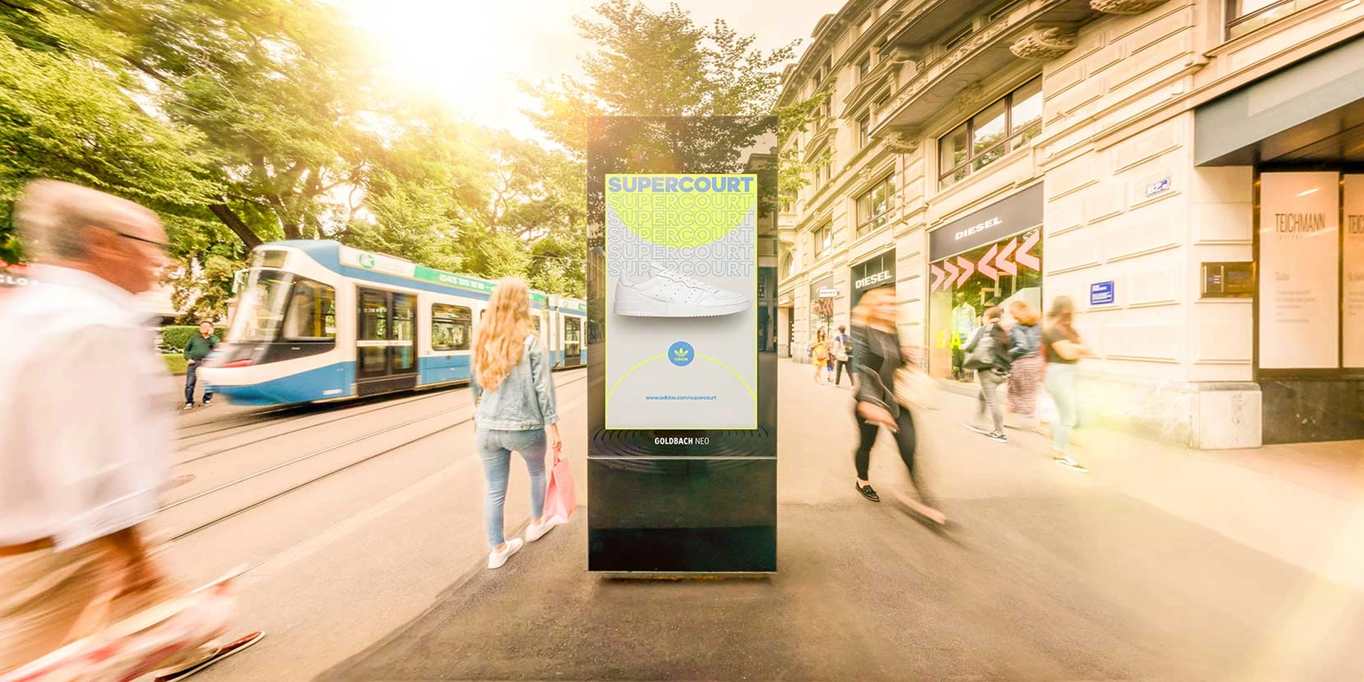 Screen on Bahnhofstrasse with people walking by