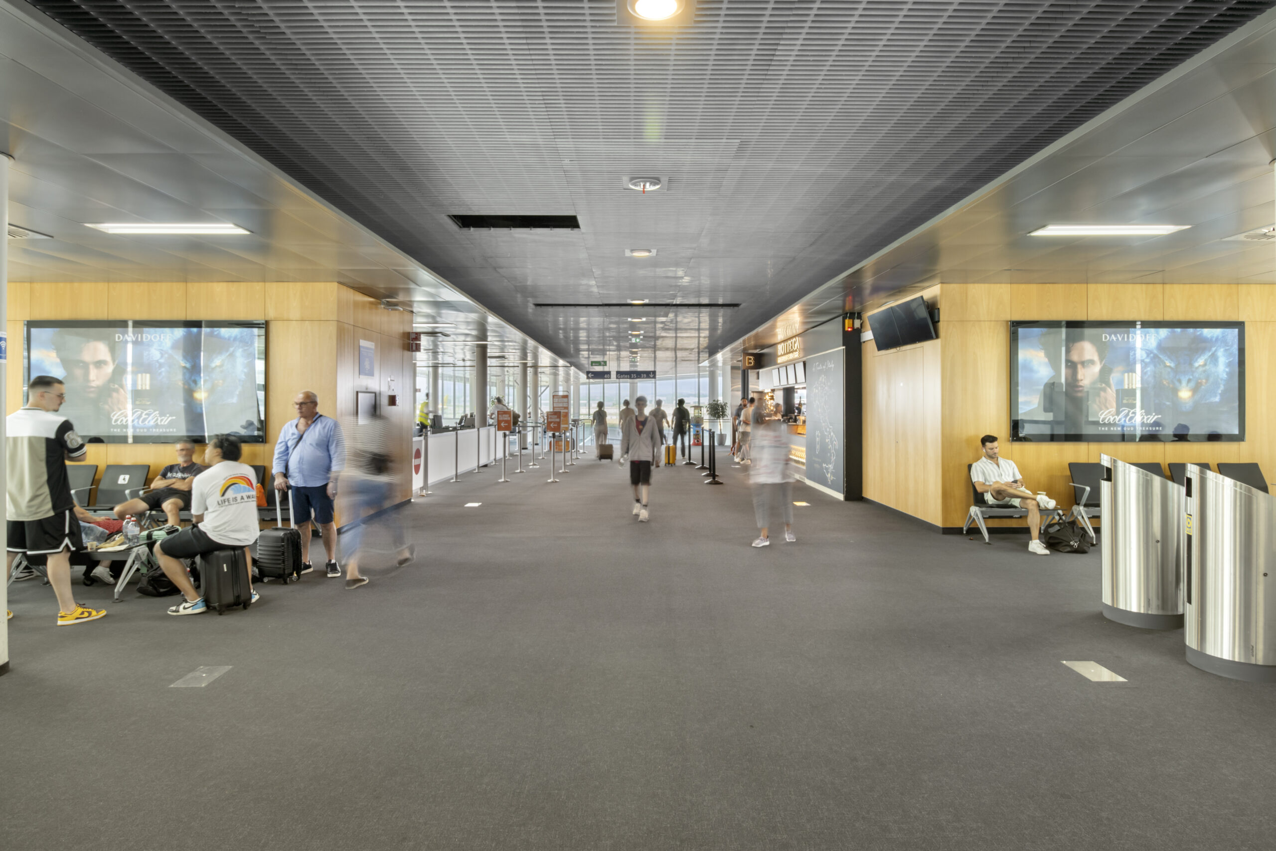 EuroAirport Basel with advertising spaces and people waiting