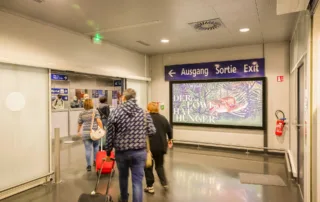 Advertising space with passersby with luggage