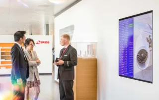 Advertising space visible and staff member advising guests