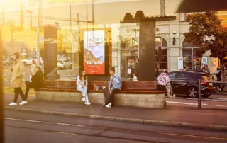 Advertising space at a tram stop and waiting people